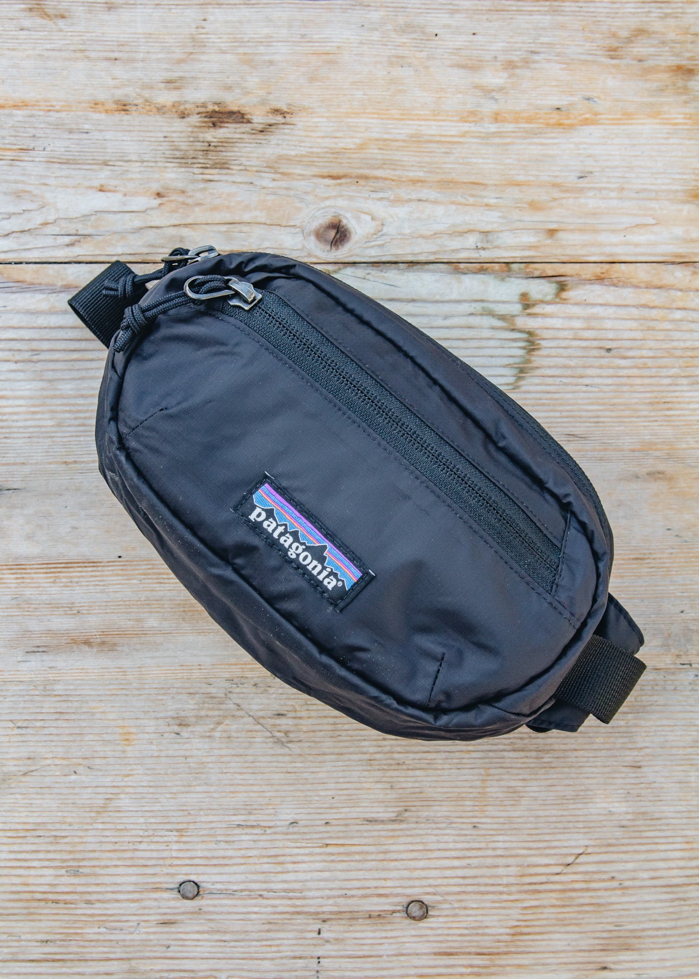 patagonia lightweight travel mini belt bag black Ultralight Hole Hip Pack The Ultralight Black Hole Mini Hip Pack by Patagonia is a versatile and lightweight accessory designed to carry essentials during exercise and fitness activities Patagonia 1L Terravia Mini Hip